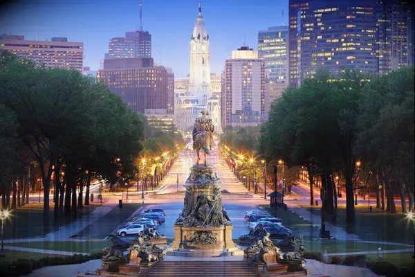philadelphia at night with ben franklin facing down the city hall building from a distance