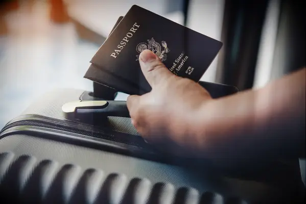 hand holding two passports for a honeymoon getaway planning