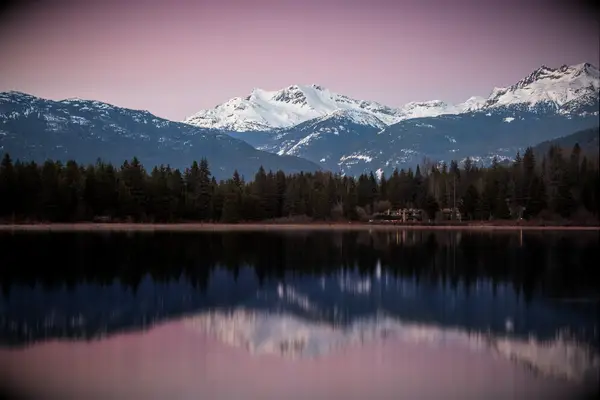 Scenic view of lake by snowcapped mountains against sky, Whistler, British Columbia, Canada