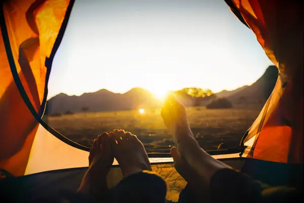Cute Couple Sunset Instagram Captions - The sun sets over a couple camping