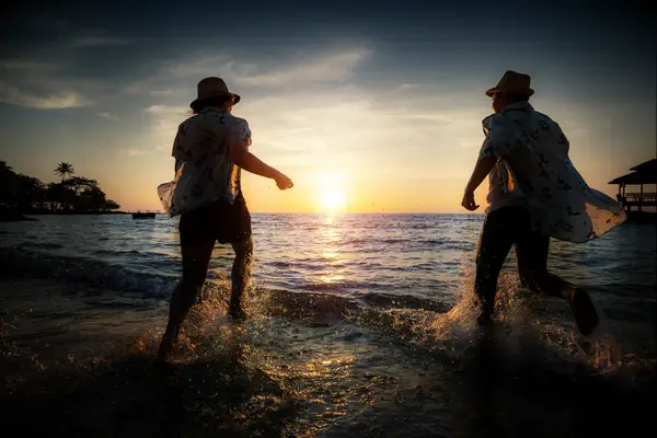 Couple running into ocean