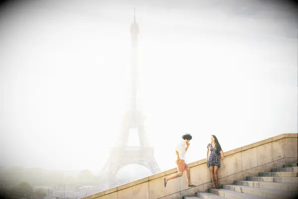 Couple in front of Eiffel Tower in Paris