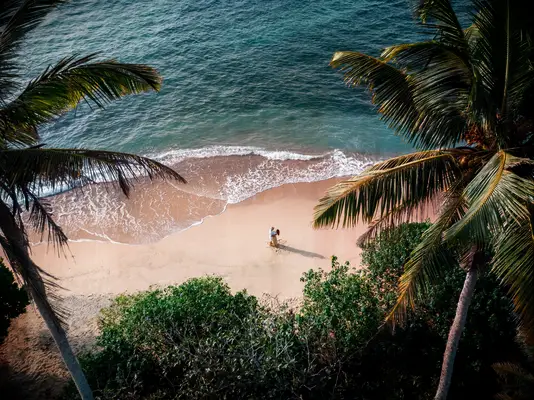 couple on a beach holding hands being romantic