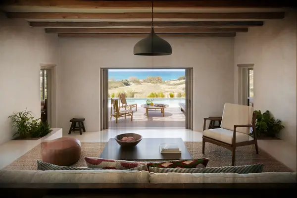 the rooster antiparos a view of a suite and villa overlooking the sea; room has beautiful neutral furnishings