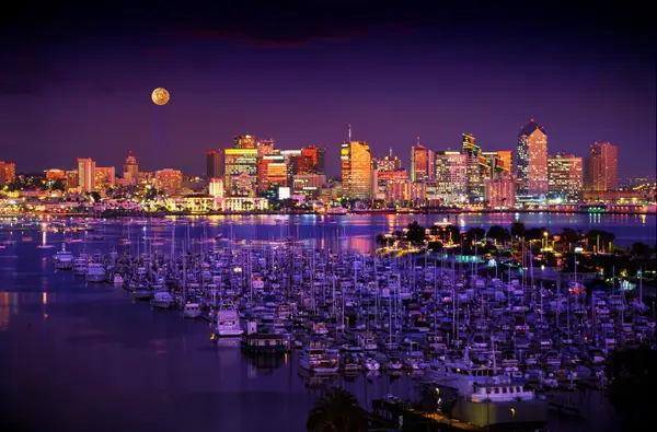 san diego marina and harbor against purple skies and a full moon