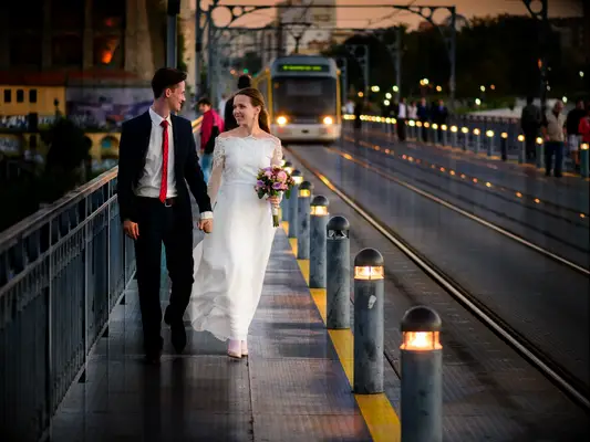 Just married on the background of the bridge in Porto, Portugal